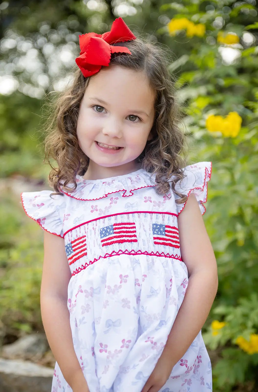 Shop Teeta Girls Ally Dress - Patriotic Bows Print - Smocked USA Flags by Shop Teeta