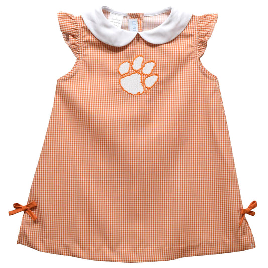 Orange checkered dress with white collar and paw print on a white background