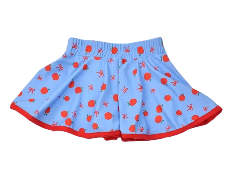 Light blue flared shorts with a red strawberry print and red trim along the hem, displayed flat against a light beige background.